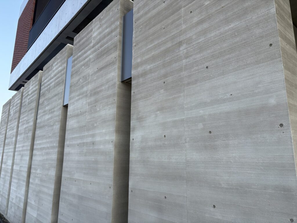 Exposed concrete facade restoration in Japan with precise color matching and joint alignment by REPRO.